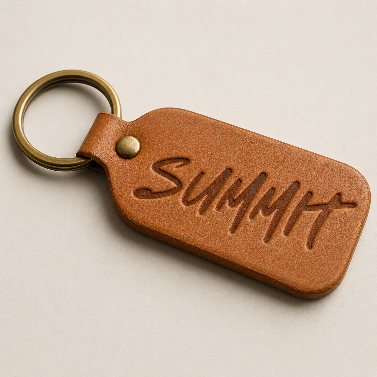 Debossed Summit logo on a leather keychain