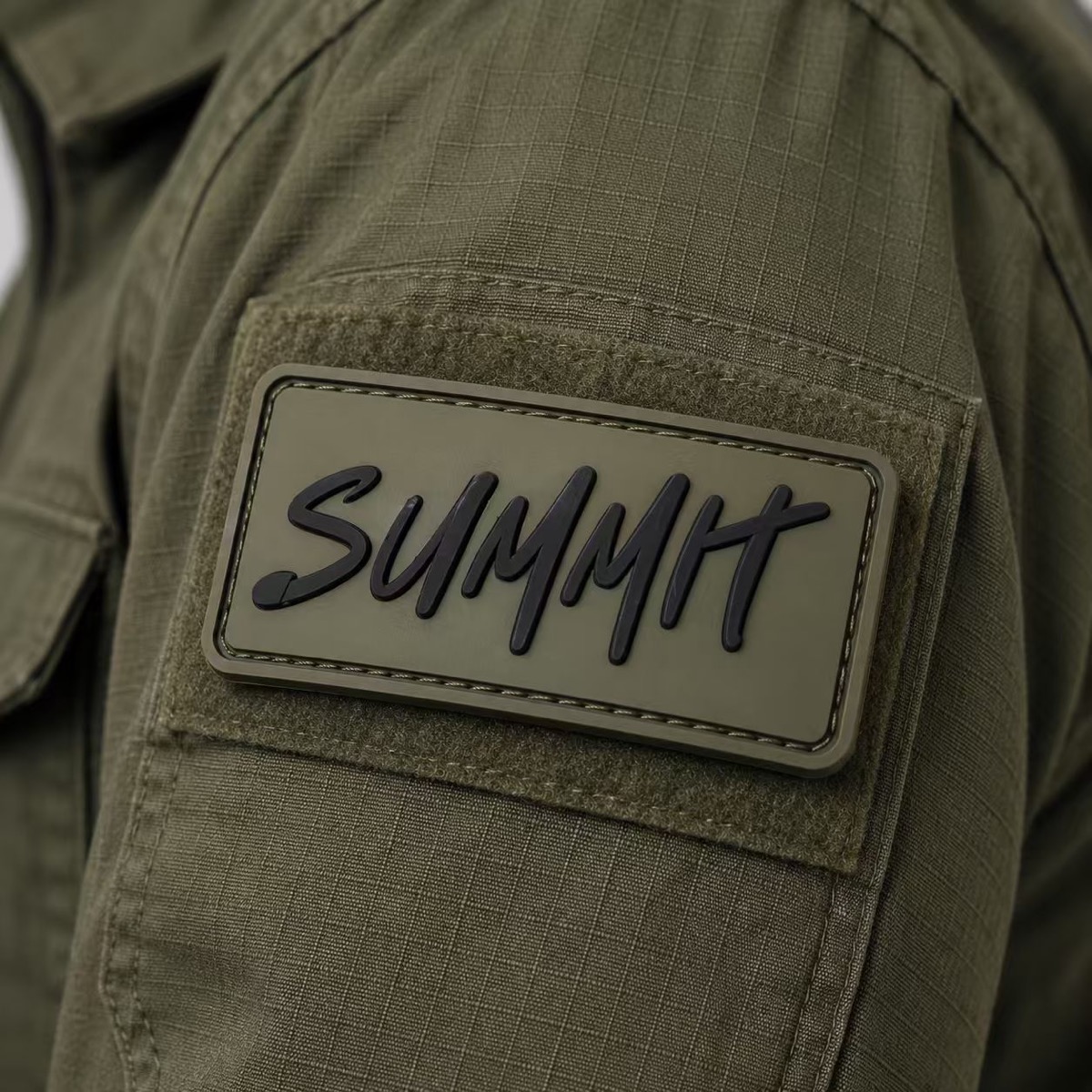 Raised Summit PVC patch on olive fabric