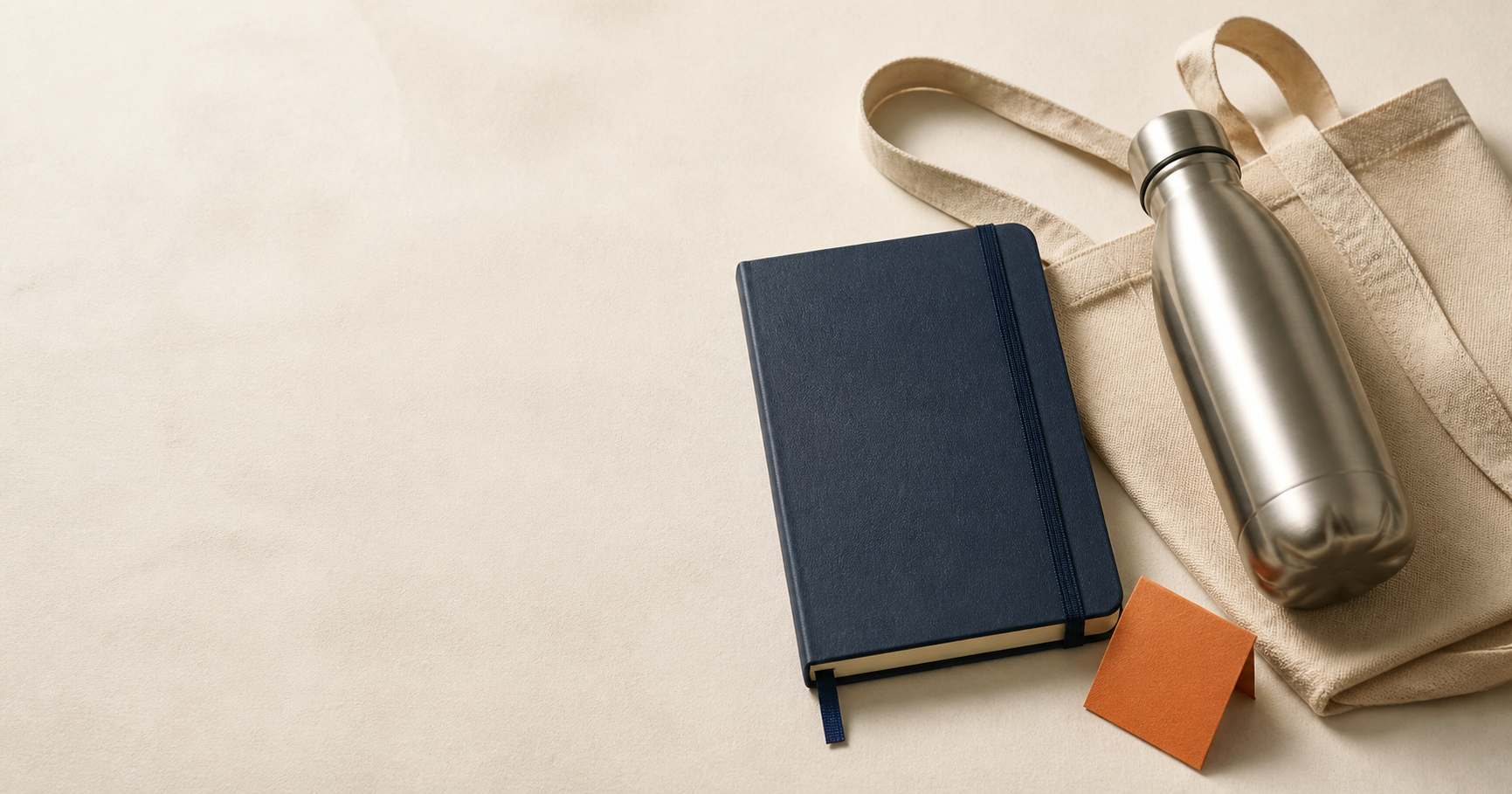 A notebook, bottle, tote, and color swatches arranged as promotional products